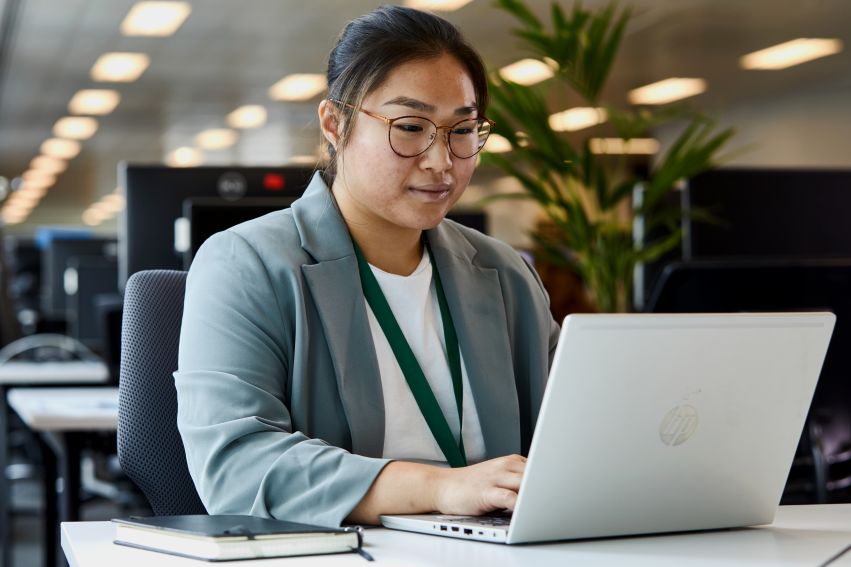 A person sits at a laptop