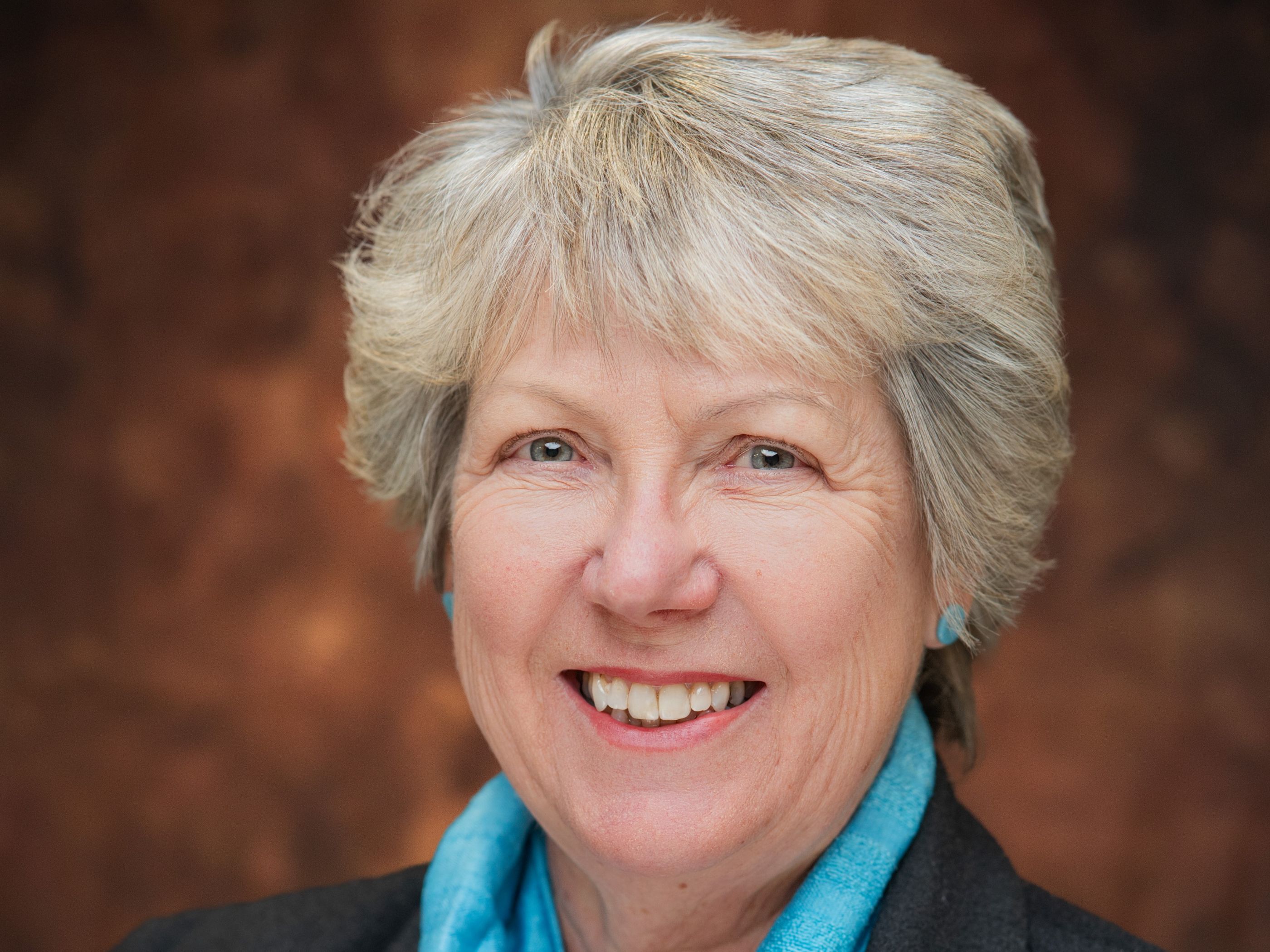 A smiling woman with short grey hair