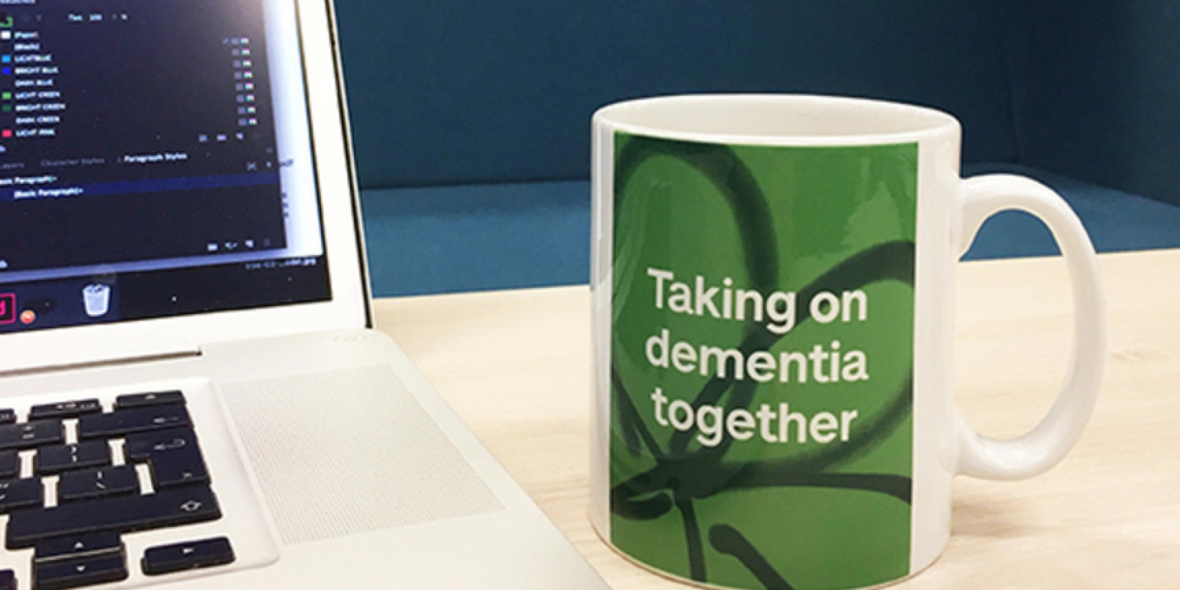 A coffee mug that reads 'Taking on dementia together'