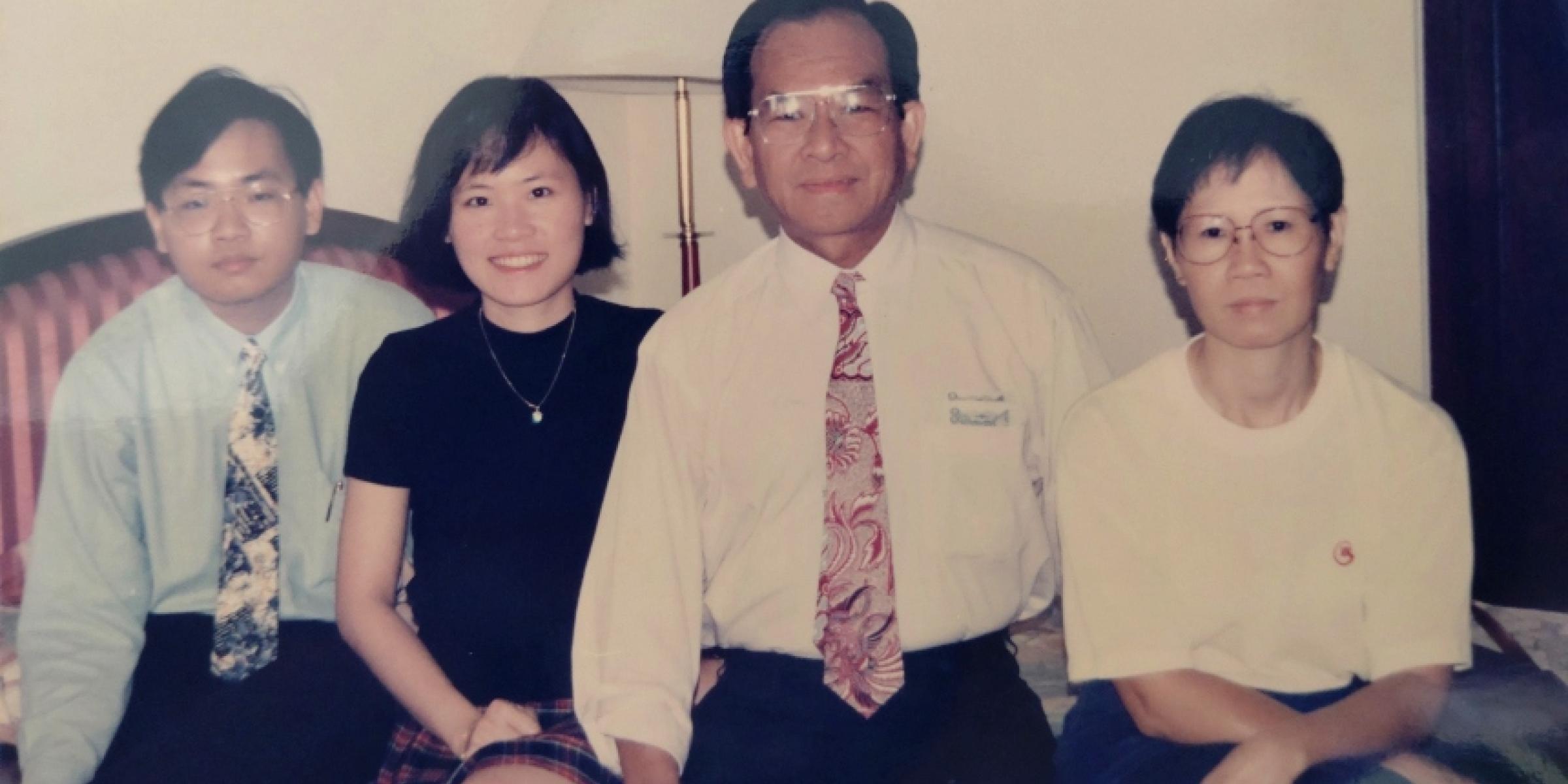 Ai Lyn, her brother and her parents sit on the sofa together