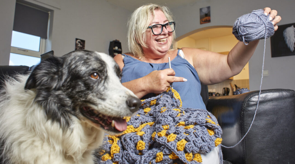 Anita knitting alongside her dog