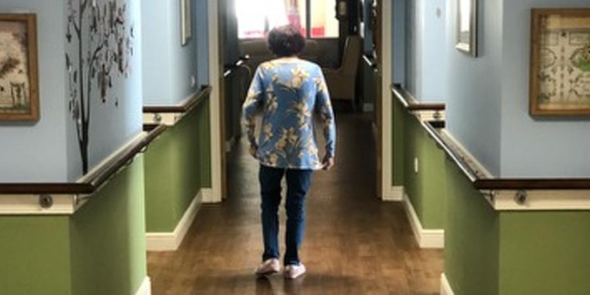Yvonne walking down a corridor