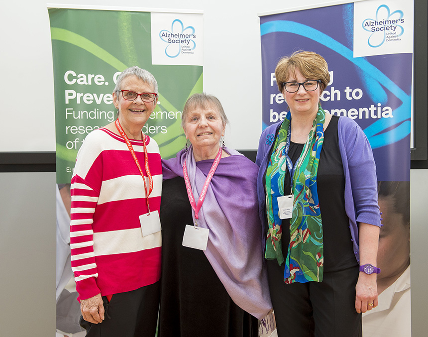 Event organisers Wendy Mitchell, Barbara Woodward-Carlton and Sandra Baker stand together in front of Alzheimer's Society banners