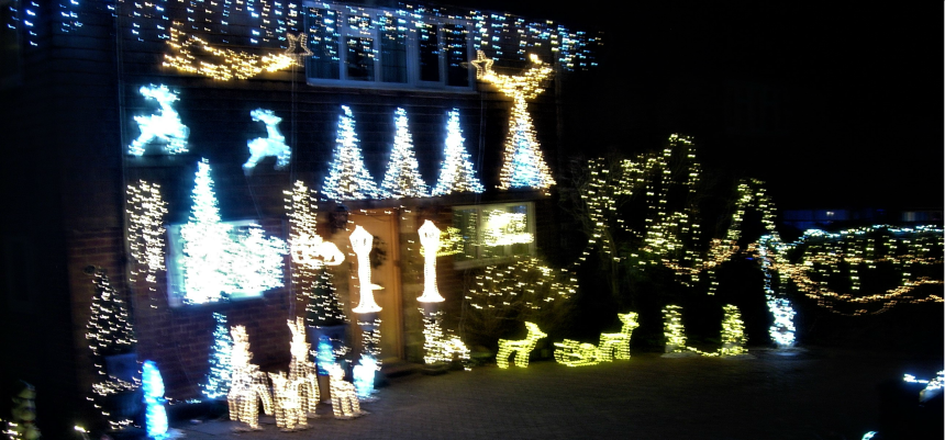 An amateur photograph of Christmas lights decorated on a house