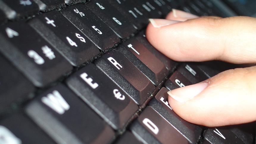 Fingers on a computer keyboard