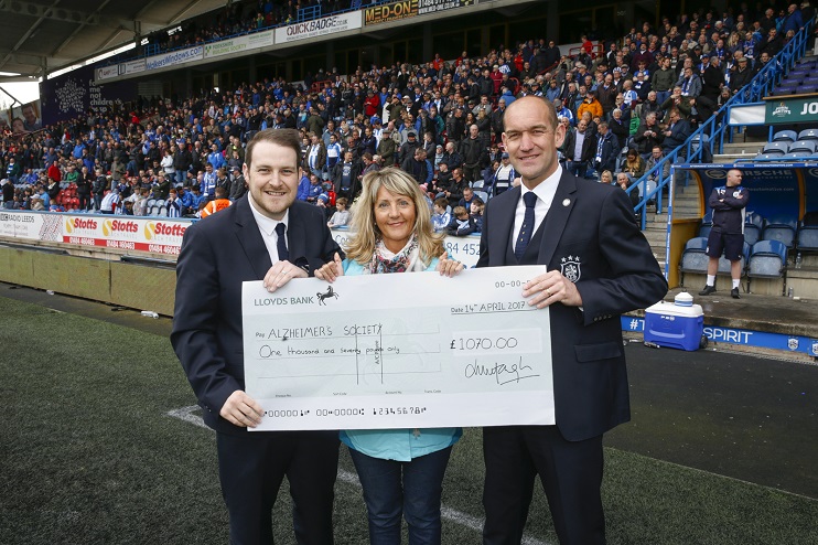 Club ambassador Andy Booth and retail manager Luke Cowan presented a cheque for £1,070 to Janette Battye