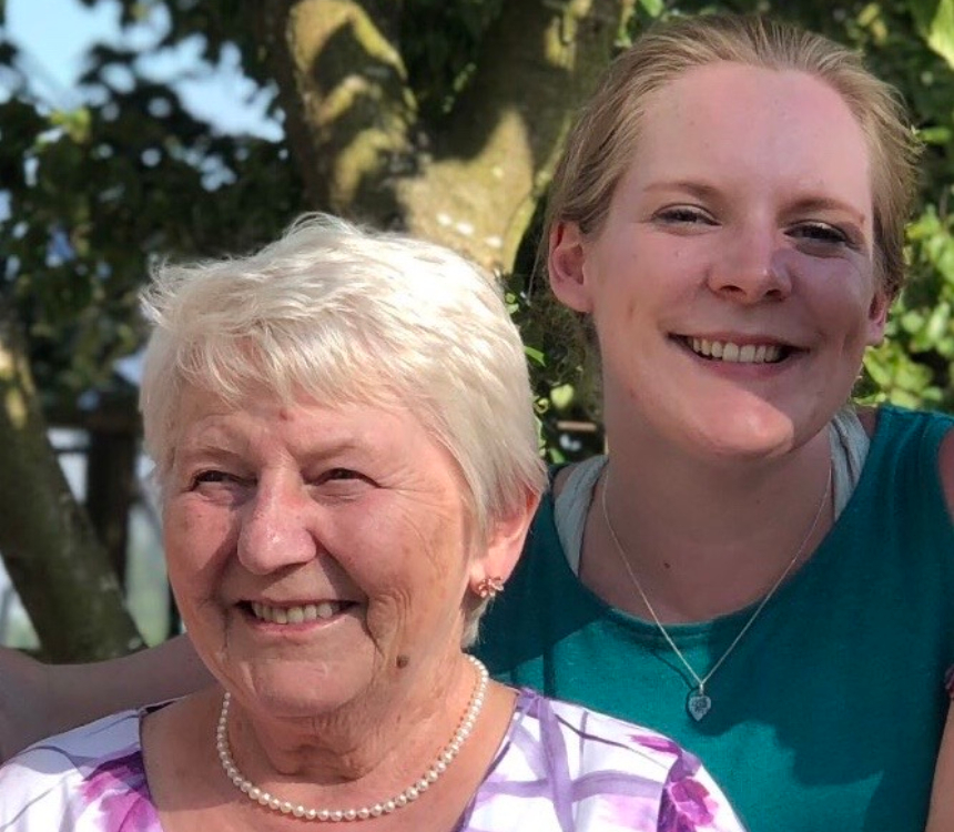 Hannah with her Nanny, smiling outdoors