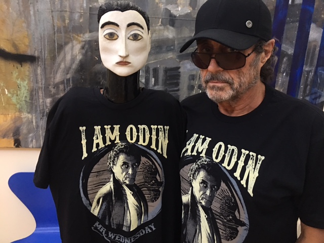 Ian McShane standing next to a mannequin 