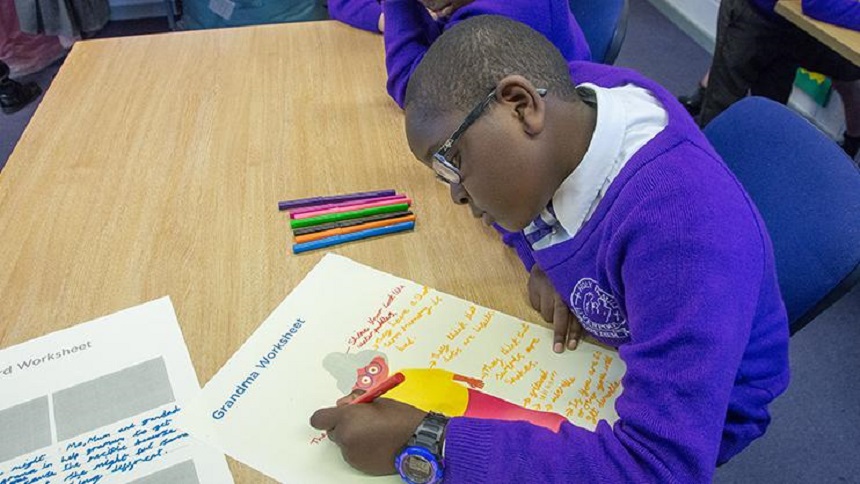 A young student writing at a desk