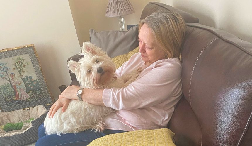 Terry pictured with her dog, Pepper, on the sofa