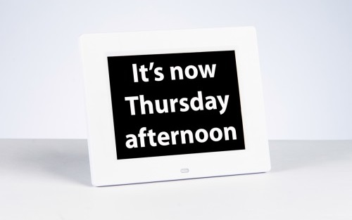 A digital clock display with a message that reads 'It's now Thursday afternoon'