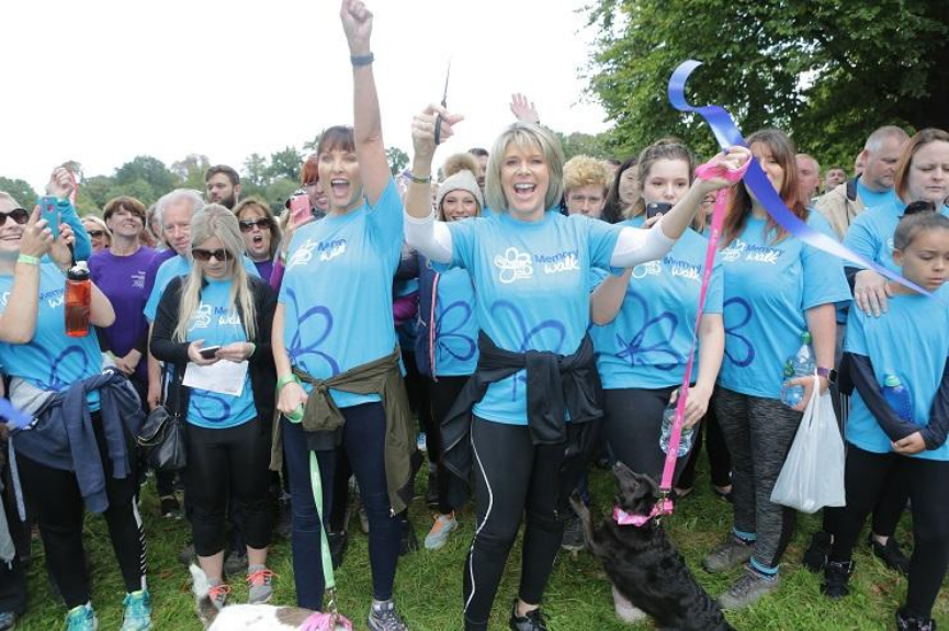 Ruth Langsford cutting the Surrey Memory Walk ribbbon with other participants behind her