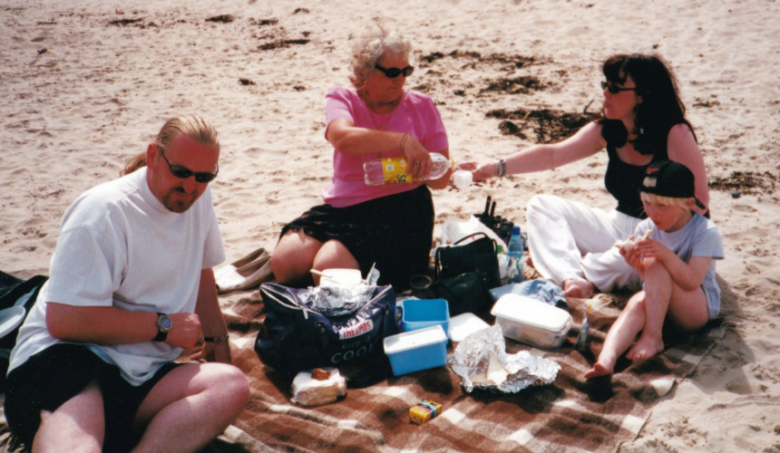 India with her parents and gran enjoying a picnic on the beach in 2001