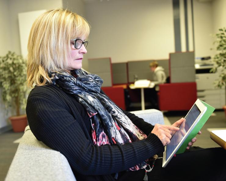 Female volunteer holding an ipad