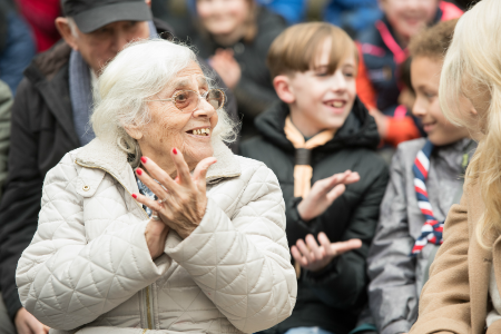 Woman with dementia clapping with group of Scouts