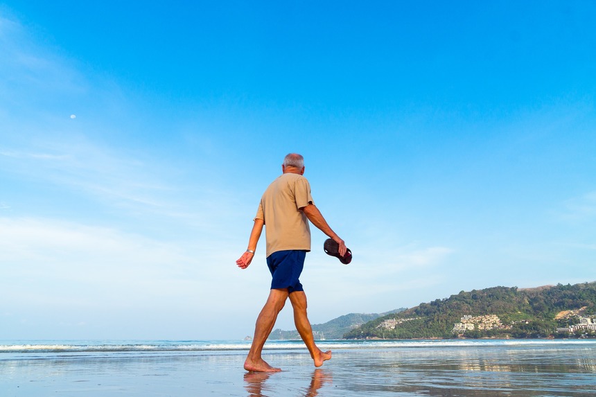 Man walking along beach