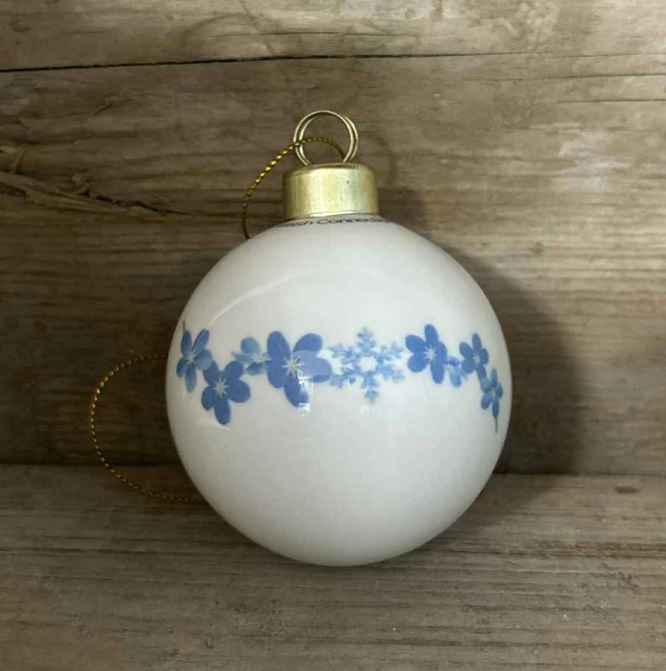 Forget-me-not bauble on a wooden background