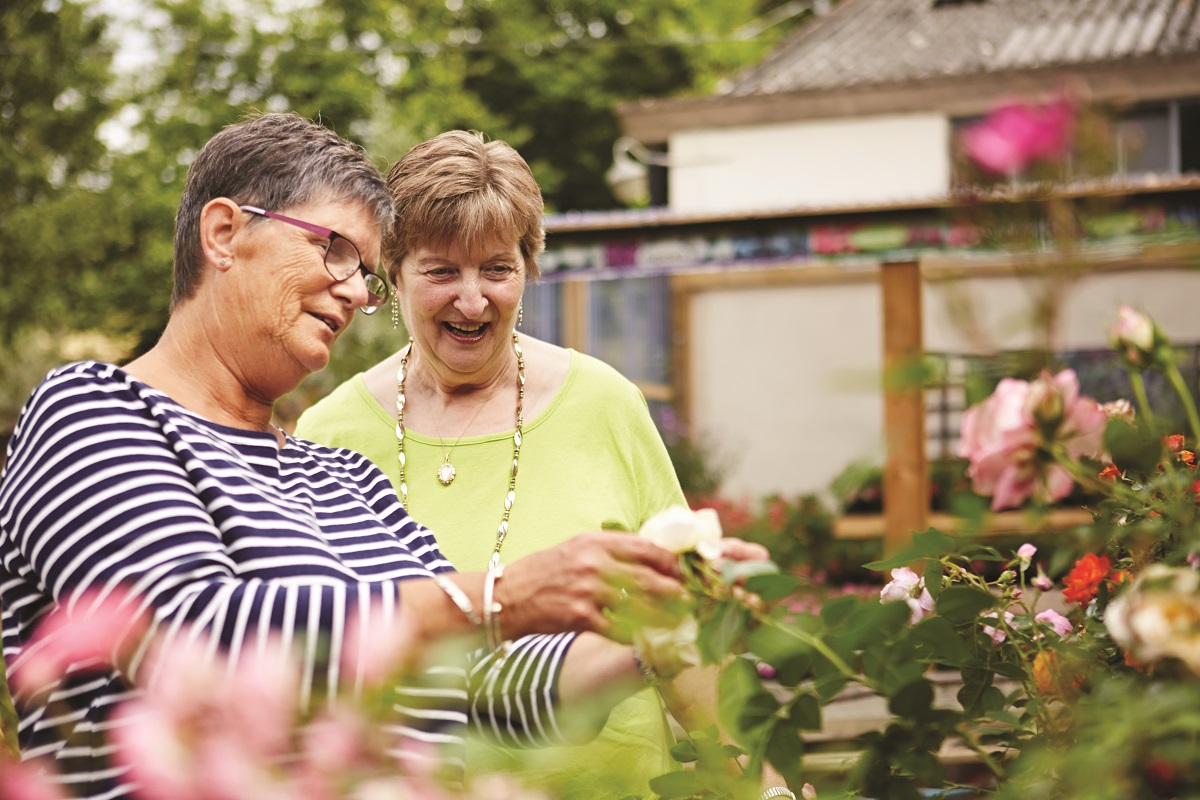 Two women stood looking at flowers