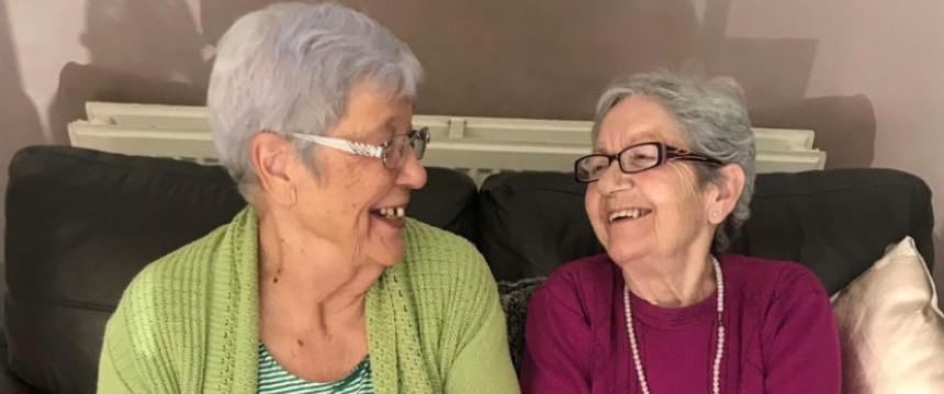 Georgia's two Grandmas, Bet and Janet, laughing and smiling with each other