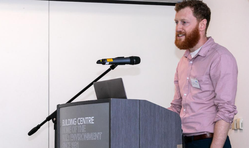 A man stands behind a podium to give an address.