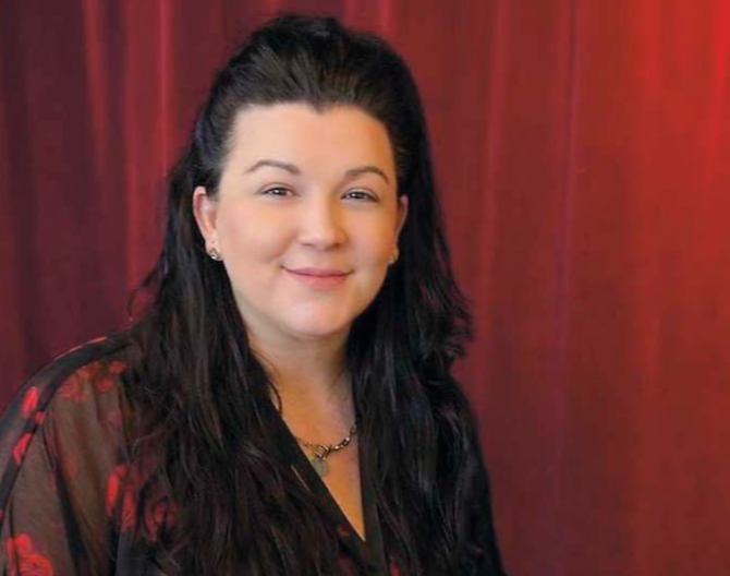 A smiling woman with dark hair 