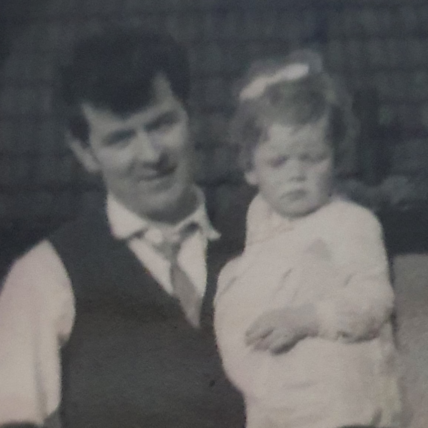 Loraine being carried as a child by her dad, Martin, in a black and white photo