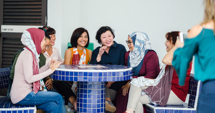 women sitting around a table laughing