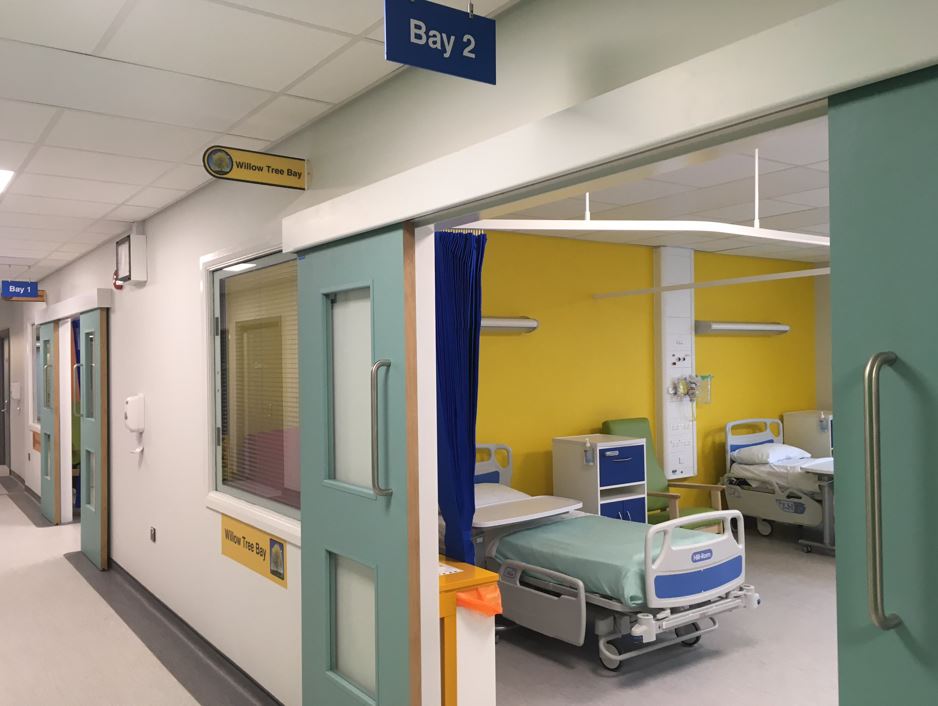 Shrewsbury hospital ward showing beds and bright coloured decoration
