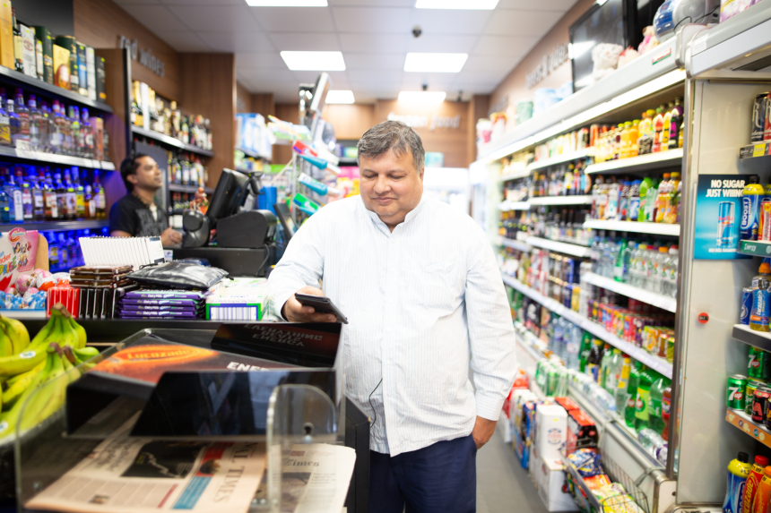 Man playing GameChanger in a local shop