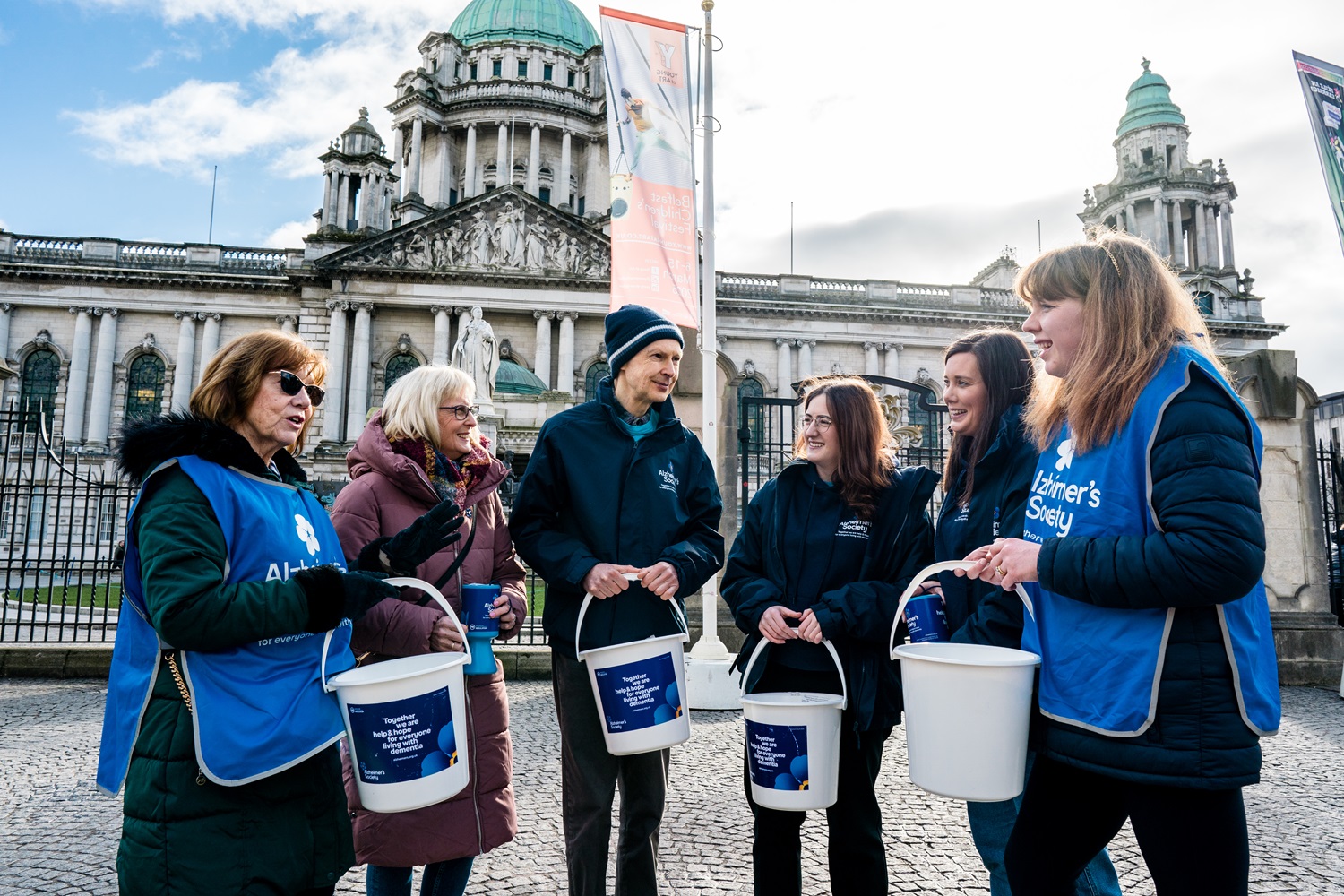 A team of volunteers outside holding collection buckets