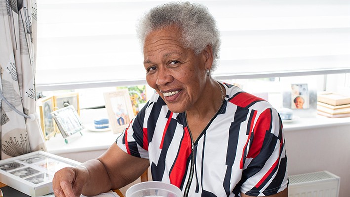 Coral Bailey with one of her stamp collectors' books