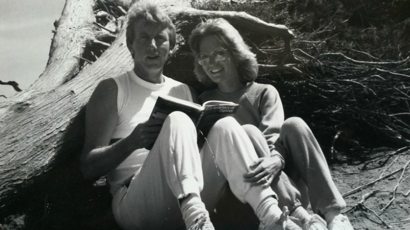 John and Lori sat outside smiling. 