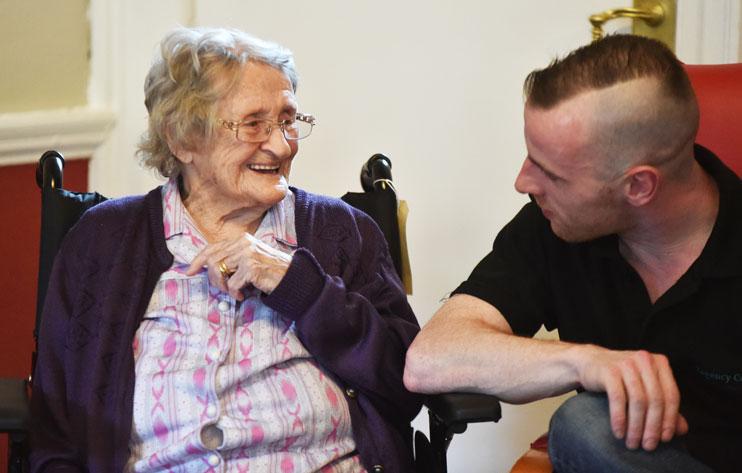 A Regency Court care home staff member speaks with a resident
