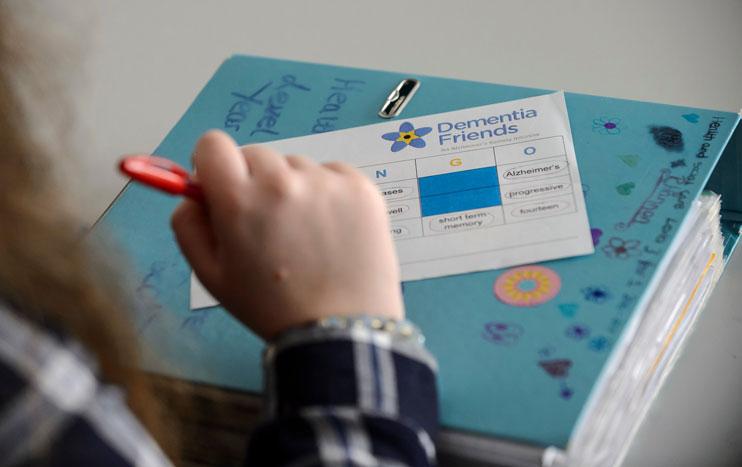 A college student completing a Dementia Friends activity