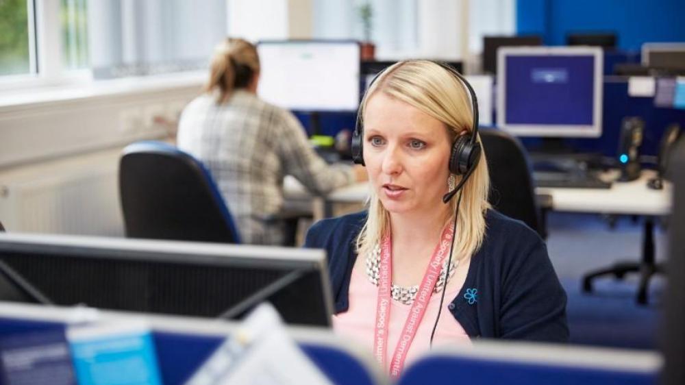 A Dementia Connect support line adviser wearing a headset