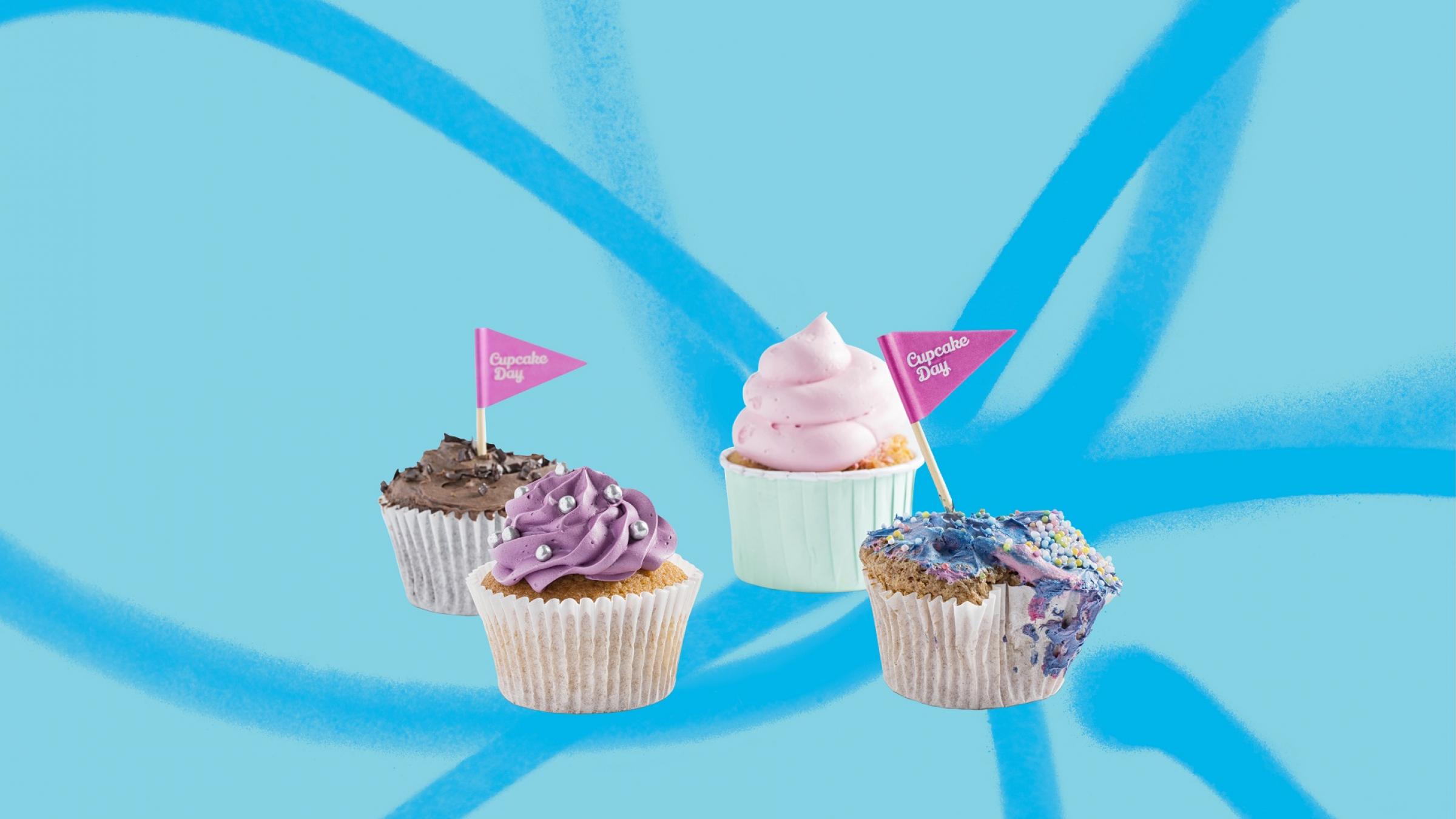 Four cupcakes on a blue background with forget-me-not flower graphic