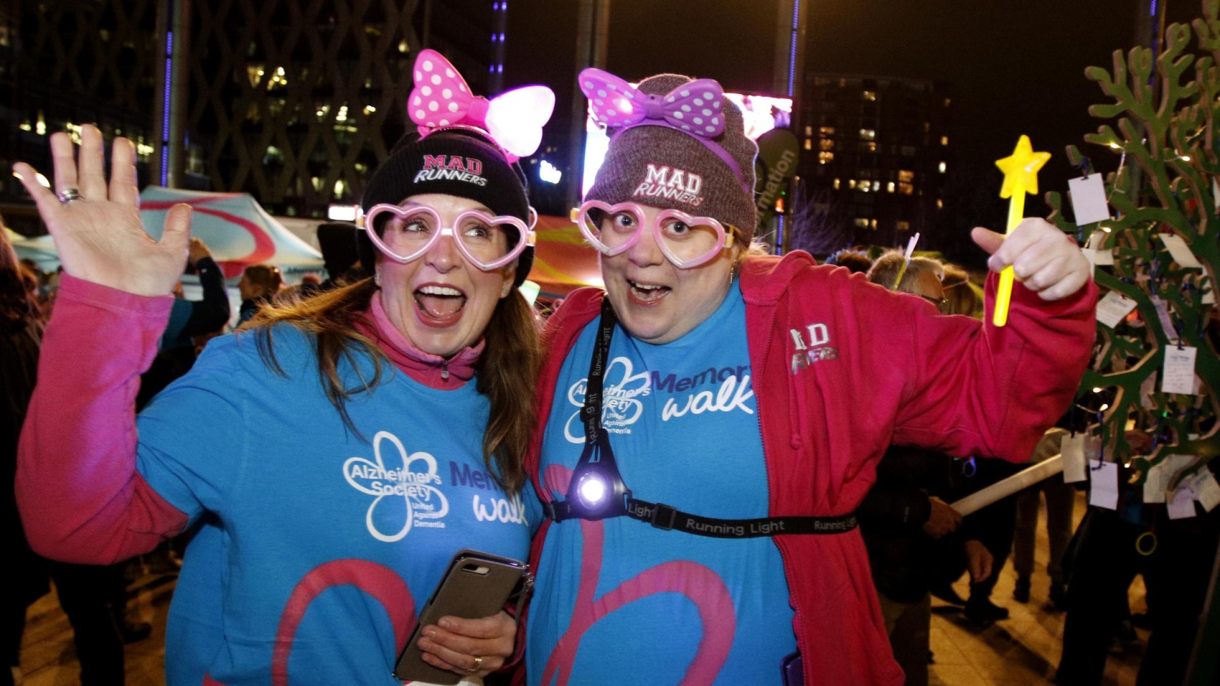 Two ladies dressed up for Glow walk smiling