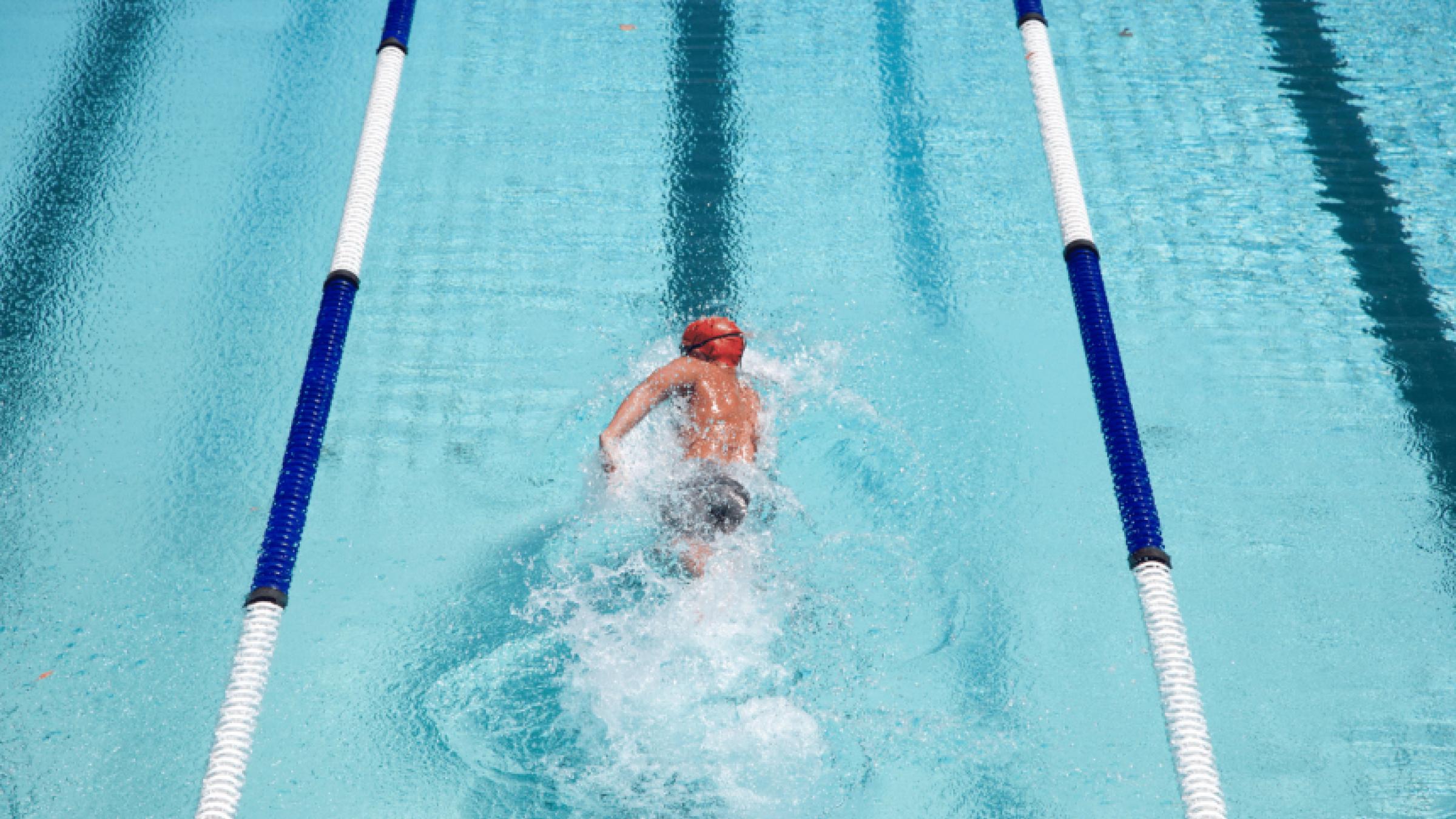 A swimmer within the lanes of a pool