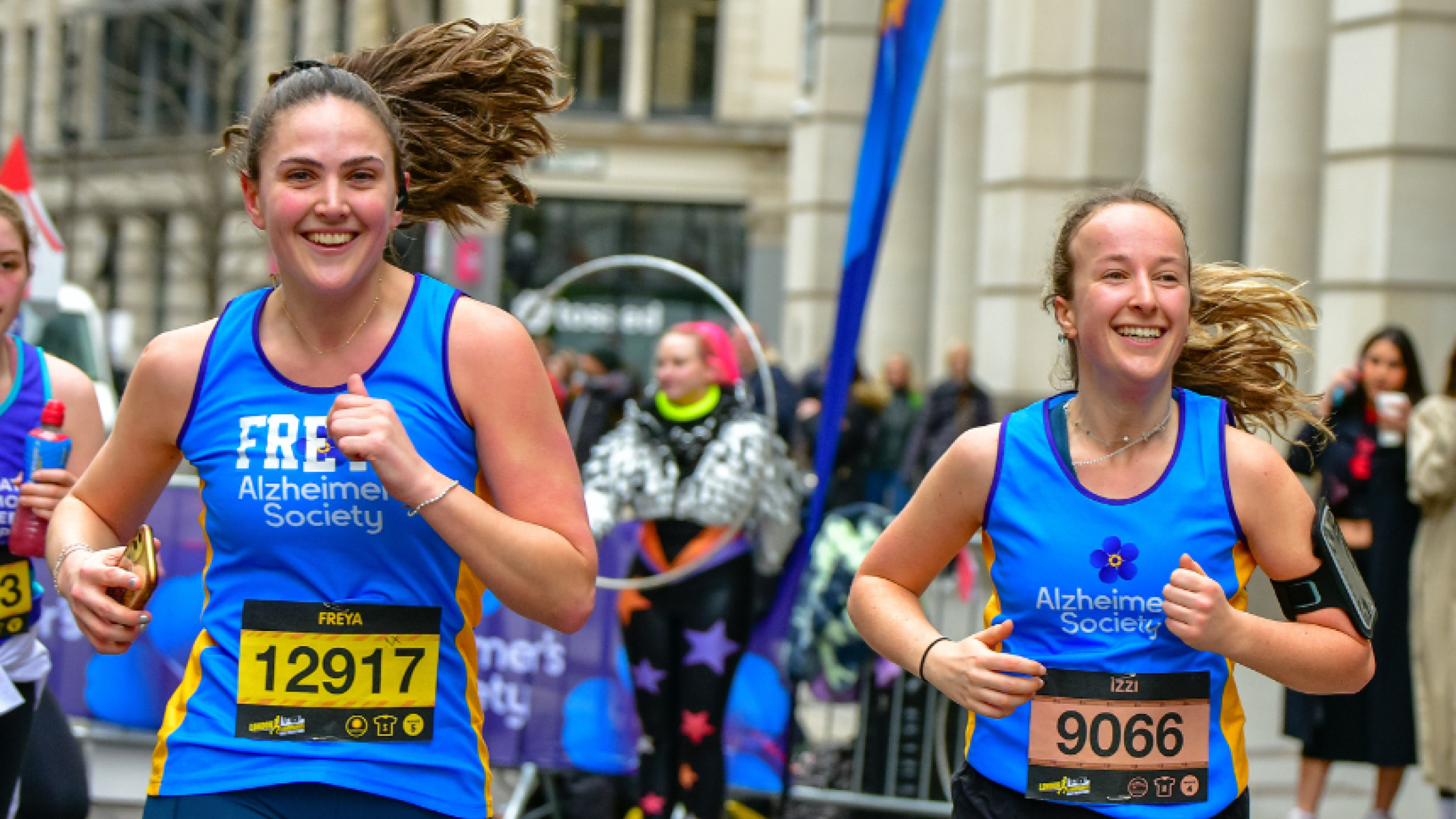 Two runners smiling
