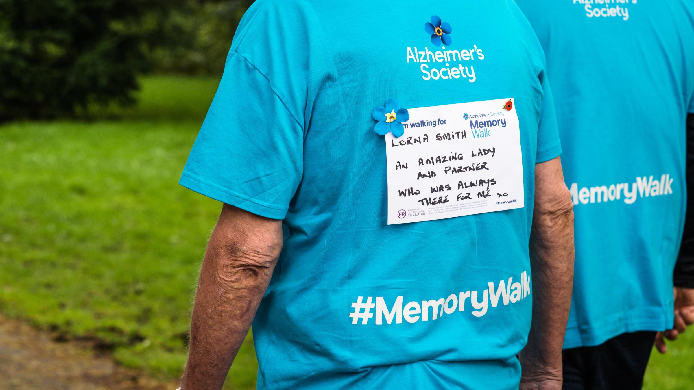 'In Memory' sign on back of t-shirt