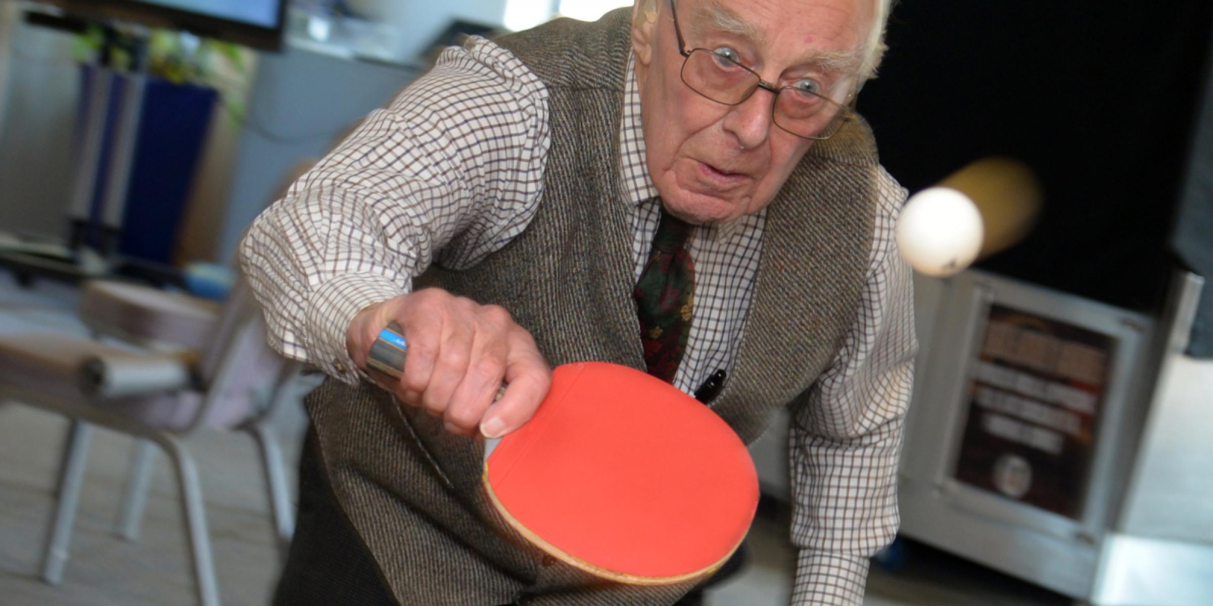 A man playing table tennis at the sports cafe