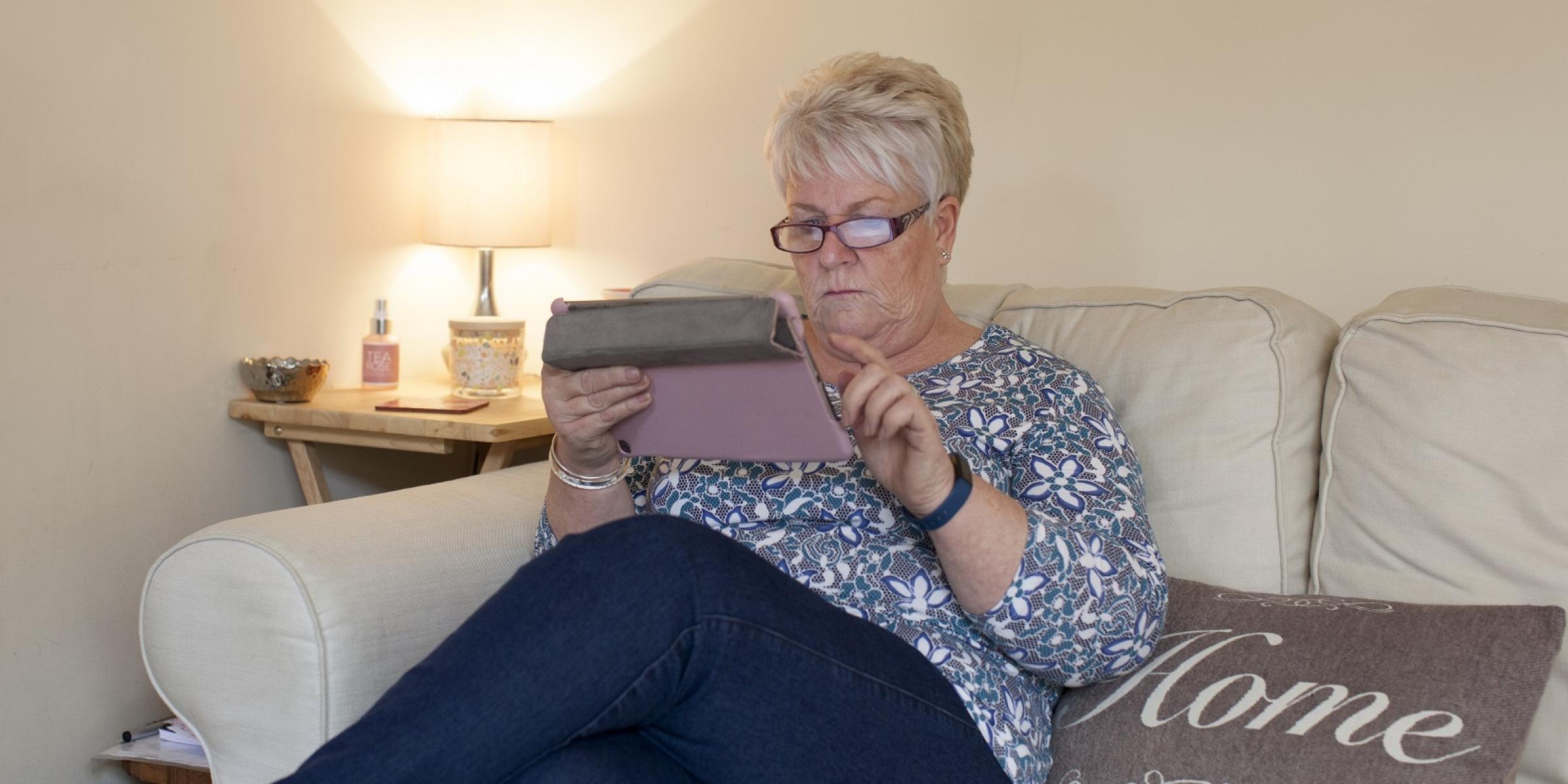 Woman looking at iPad tablet - dementia information