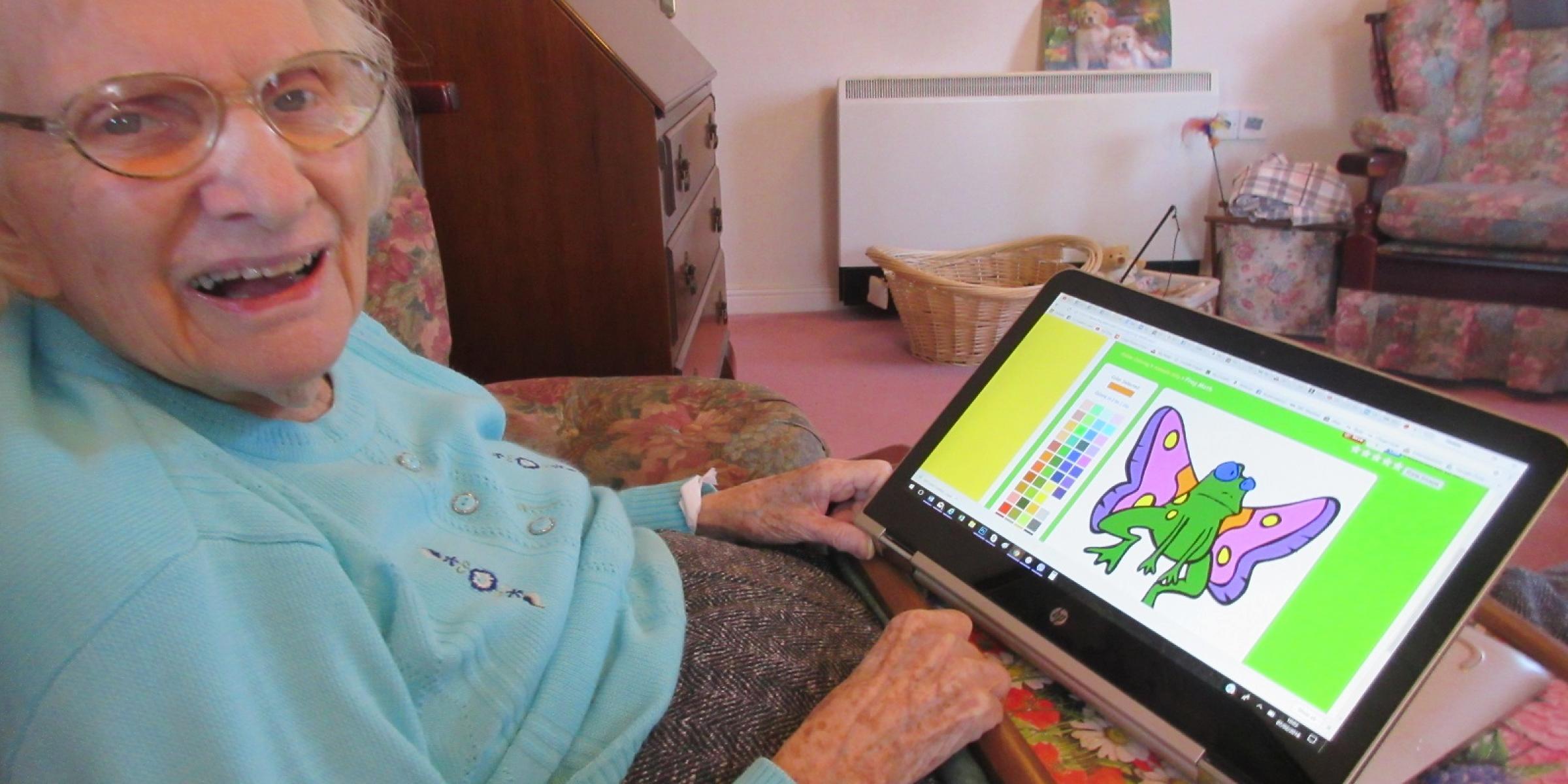 Heather's mum colouring on a tablet computer