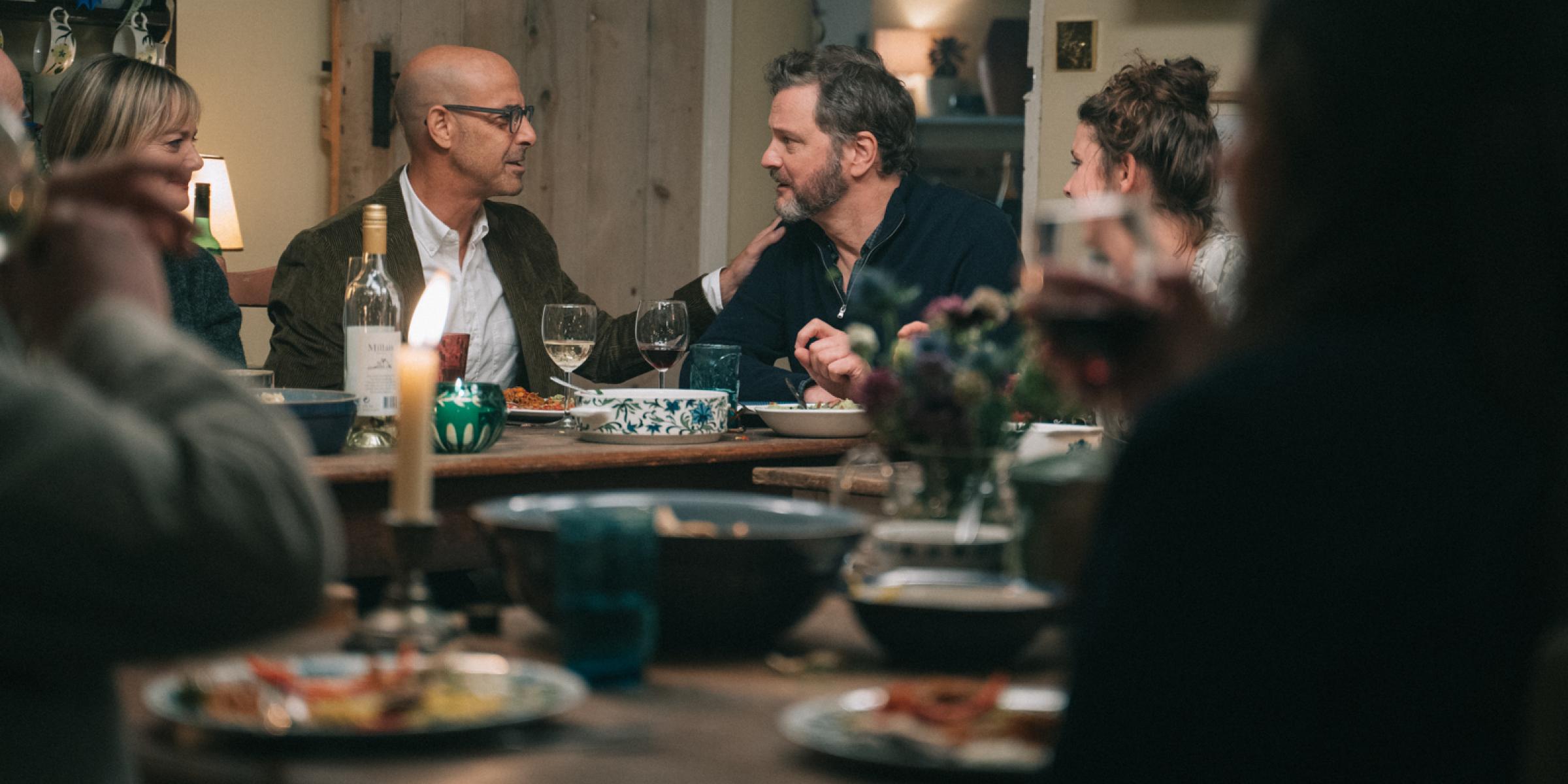 Actors Colin Firth and Stanley Tucci at a dinner party during the film Supernova