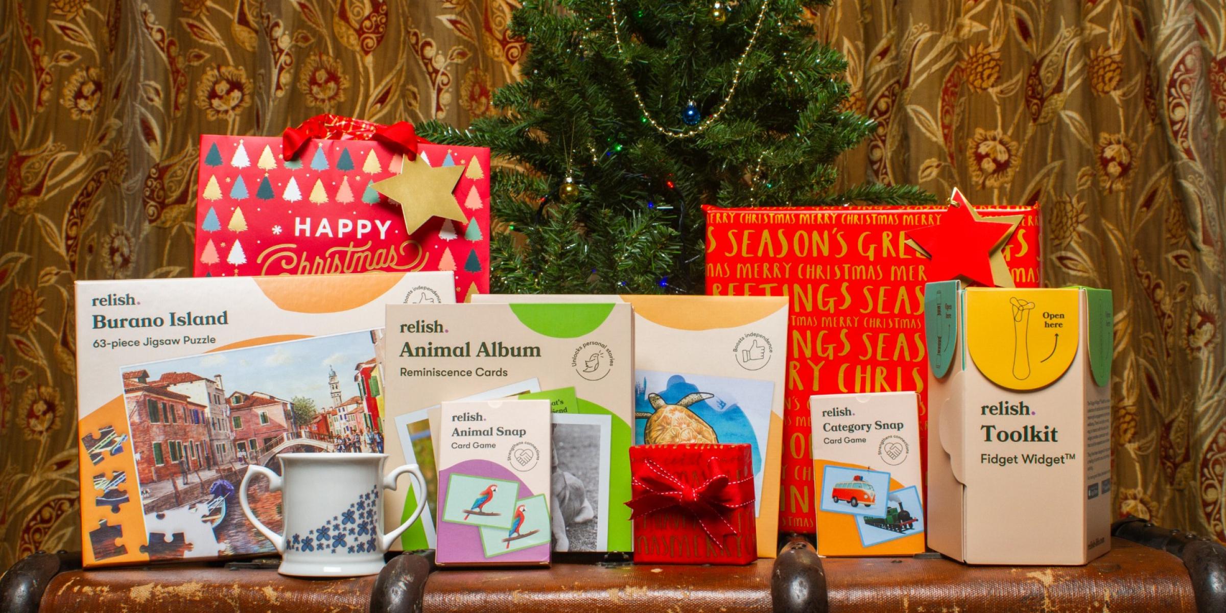 A selection of Christmas gifts in front of a Christmas tree