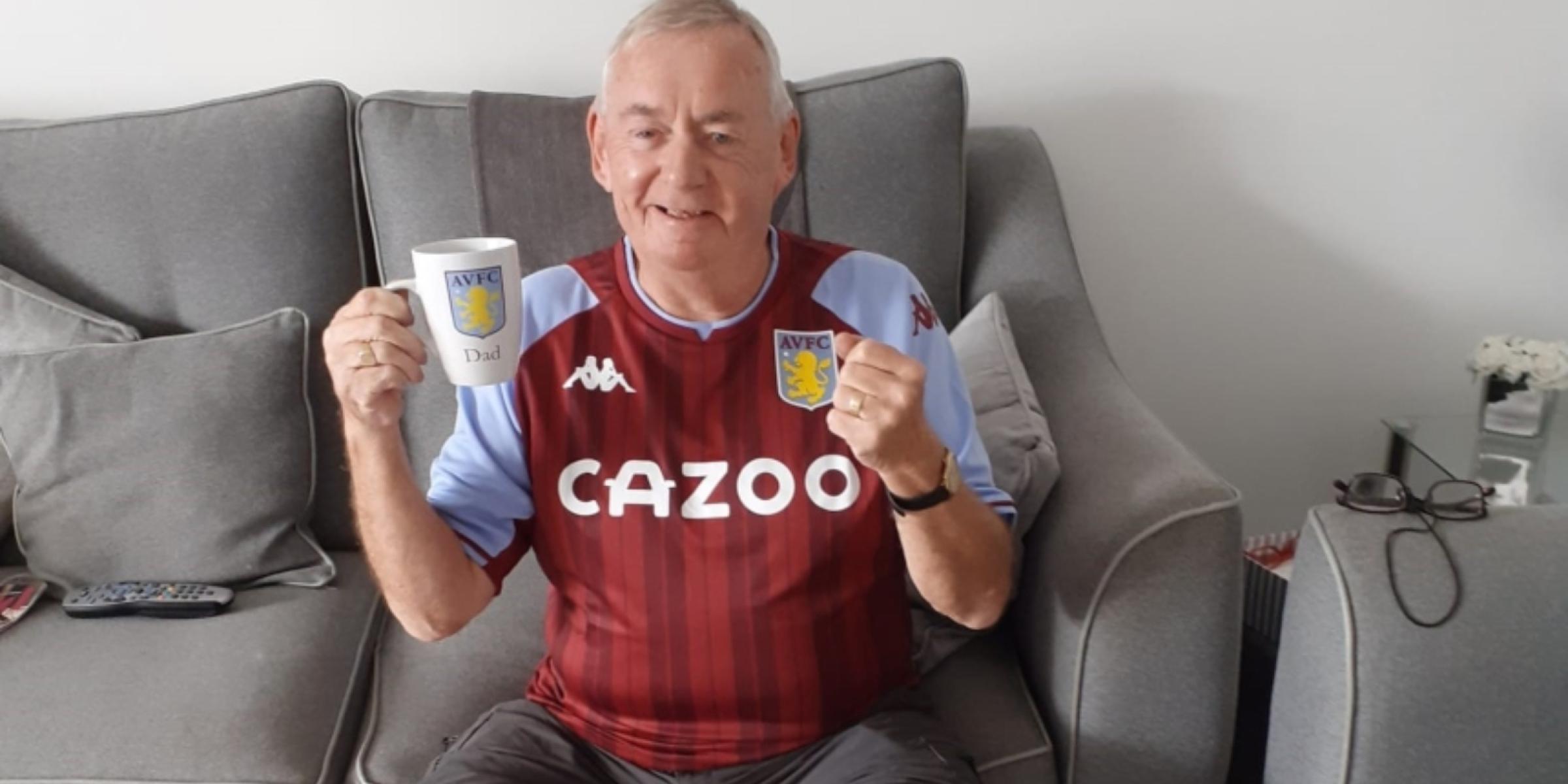 Peter wearing an Aston Villa shirt and holding a matching mug, smiling and with a clenched fist in excitement