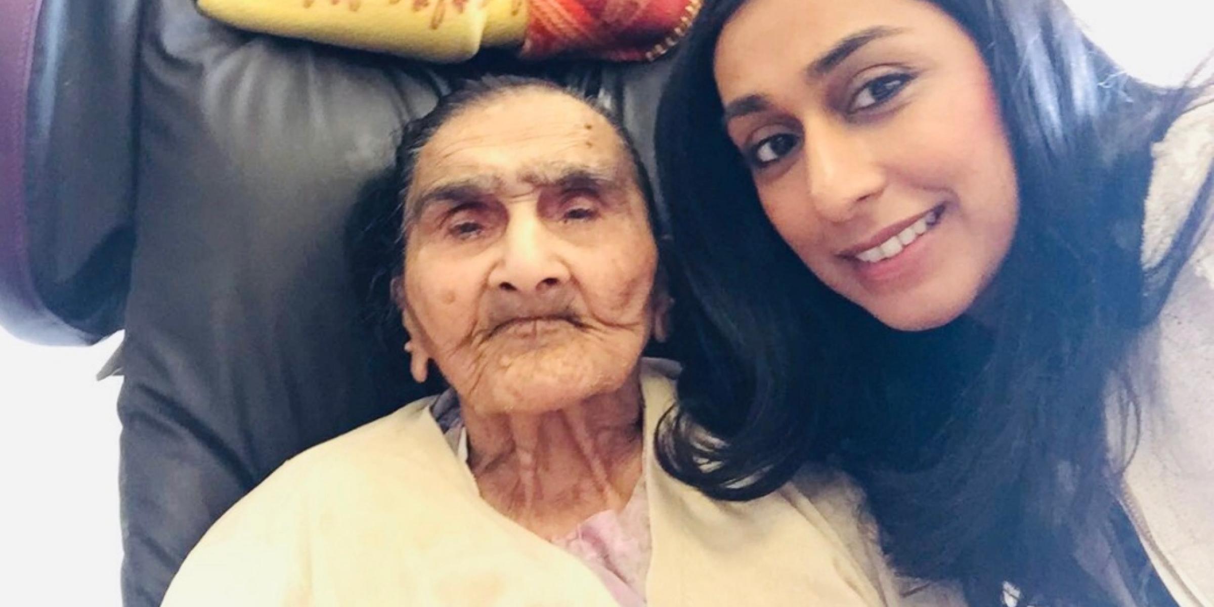 Lavina taking a picture with her Nani, who is sat in an armchair