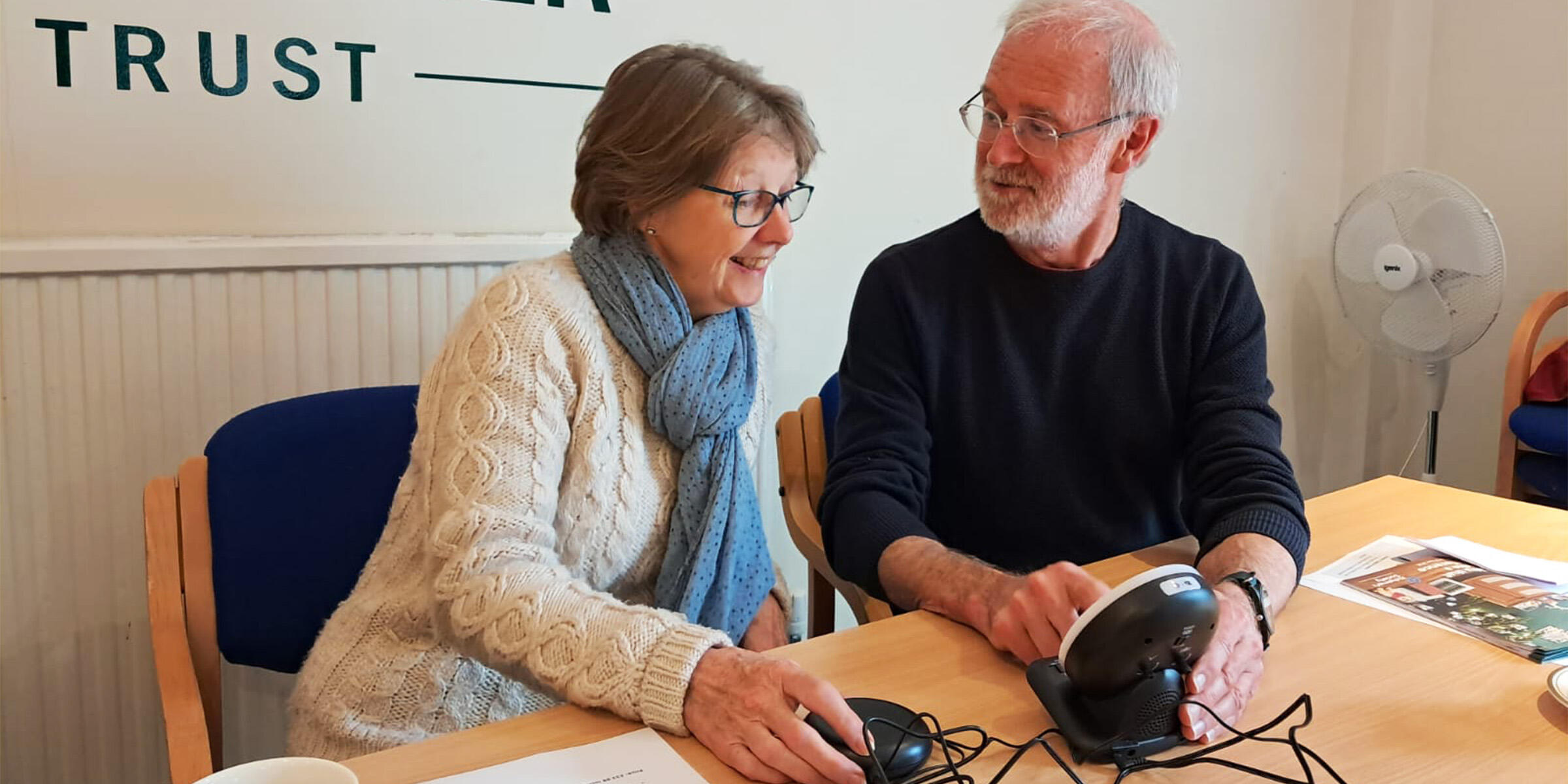 People looking at an alarm device