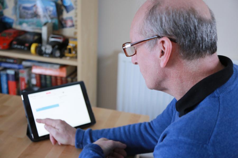 A man with dementia using a tablet computer