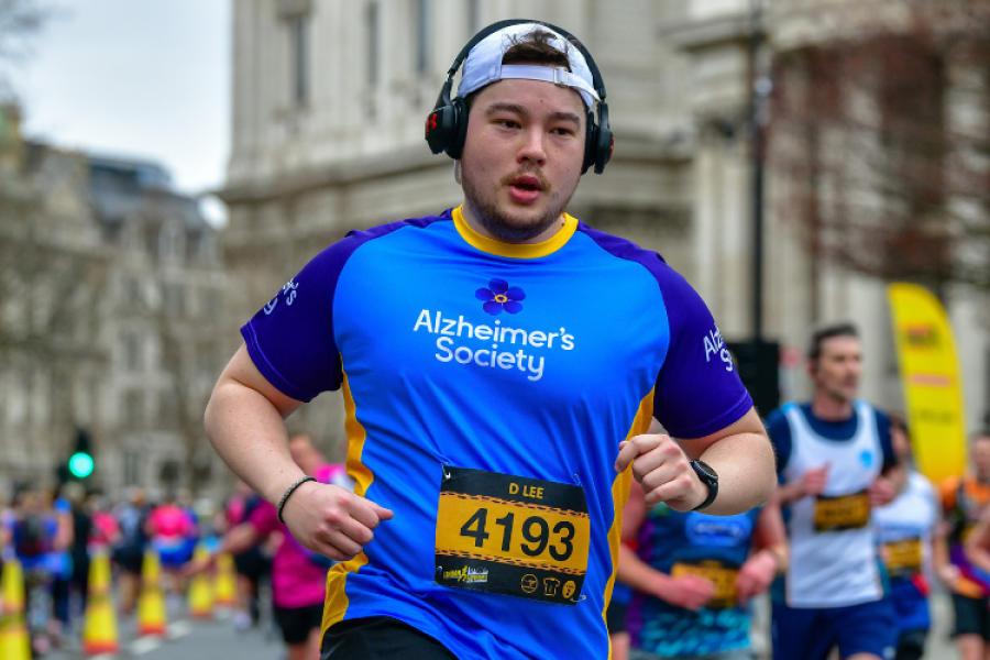 Alzheimer's Society running and wearing cap and headphones